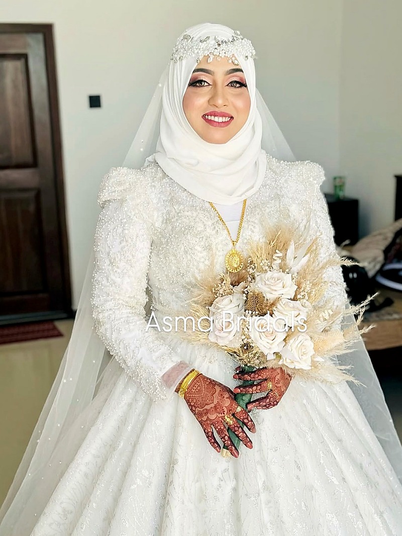 Bride in ivory gown with dried floral bouquet